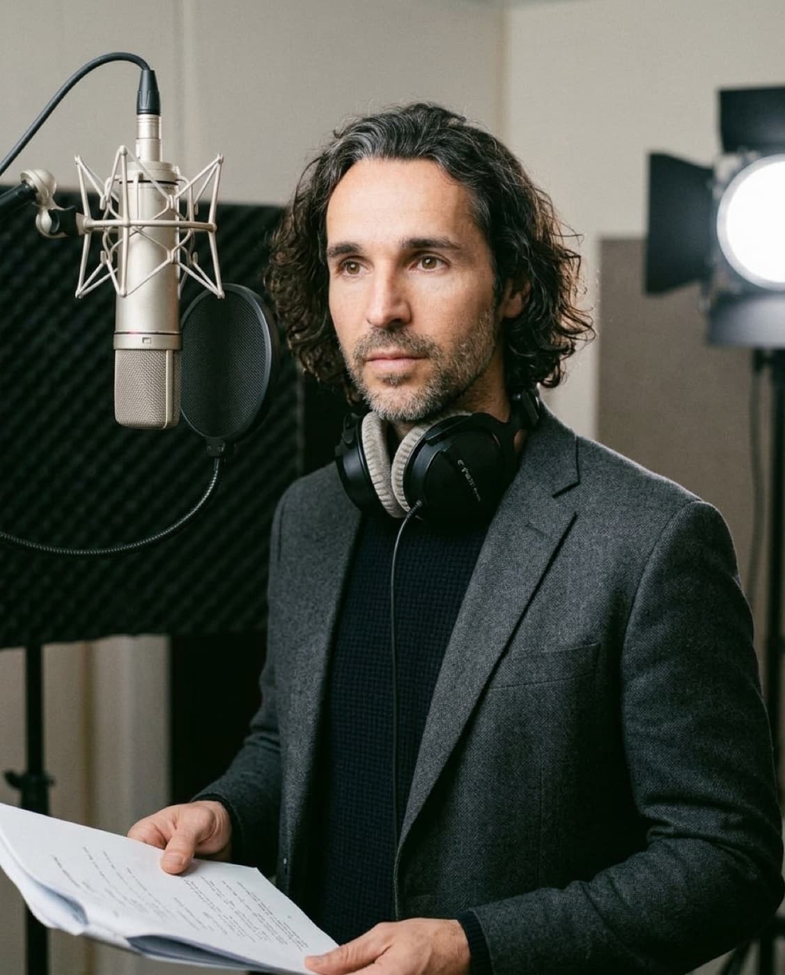 CJ Emerson recording native English voiceover and reviewing a script in a recording studio